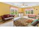 Bedroom with yellow walls and carpet, two beds, a small couch, and a dresser provides a comfortable and inviting space at 1488 Lachona Ne Ct, Atlanta, GA 30329