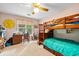 Bright bedroom featuring a bunk bed, a work desk, and a large window at 1488 Lachona Ne Ct, Atlanta, GA 30329
