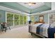 Spacious bedroom boasts tray ceilings, large windows with backyard views, and neutral carpet at 1488 Lachona Ne Ct, Atlanta, GA 30329