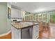 Kitchen island with granite countertop, white cabinets, and stainless steel dishwasher at 1488 Lachona Ne Ct, Atlanta, GA 30329