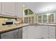 View of the kitchen area with granite countertops, white cabinets and a breakfast area at 1488 Lachona Ne Ct, Atlanta, GA 30329