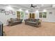 Spacious living room with two sofas, natural light, and neutral carpet at 1488 Lachona Ne Ct, Atlanta, GA 30329