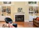 Cozy living room featuring a fireplace, built-in bookshelves, and hardwood floors at 1488 Lachona Ne Ct, Atlanta, GA 30329