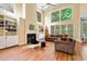 Spacious living room featuring large windows, a fireplace, and built-in bookshelves at 1488 Lachona Ne Ct, Atlanta, GA 30329