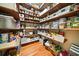 Well-stocked pantry with wooden shelving, white storage bins, and hardwood floors provides ample storage space at 1488 Lachona Ne Ct, Atlanta, GA 30329