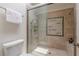 Tiled shower with glass door, a shower head, and stylish mosaic tile detail at 1757 E Clifton Ne Rd, Atlanta, GA 30307