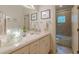 Well-lit bathroom with a modern vanity, decorative accents, and a view of the shower at 1757 E Clifton Ne Rd, Atlanta, GA 30307