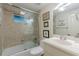 This bathroom boasts a tiled shower over a tub, toilet, and vanity with sink and a framed mirror at 1757 E Clifton Ne Rd, Atlanta, GA 30307