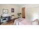 Well-lit bedroom with hardwood floors, a desk, and a closet at 1757 E Clifton Ne Rd, Atlanta, GA 30307