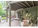 Spacious outdoor deck with a cozy seating area, plants, and view of surrounding greenery at 1757 E Clifton Ne Rd, Atlanta, GA 30307