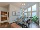 Elegant dining room featuring a glass table, statement lighting, and views of kitchen at 1757 E Clifton Ne Rd, Atlanta, GA 30307