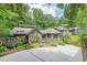Beautiful exterior with stone accents, lush greenery, and a private driveway at 1757 E Clifton Ne Rd, Atlanta, GA 30307
