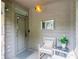 Inviting front porch with cushioned seating and a decorative hanging light fixture at 1757 E Clifton Ne Rd, Atlanta, GA 30307