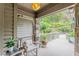 View of the home's porch featuring stone columns, a seating area, and a lush green view at 1757 E Clifton Ne Rd, Atlanta, GA 30307