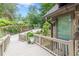 Serene landscape surrounding the home with a stone wall, lush plantings, and a driveway at 1757 E Clifton Ne Rd, Atlanta, GA 30307