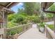 Beautiful front yard featuring mature landscaping, a stone retaining wall, and a curved driveway at 1757 E Clifton Ne Rd, Atlanta, GA 30307