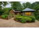 Inviting front yard with lush landscaping and a charming bridge leading to the stone and wood facade home at 1757 E Clifton Ne Rd, Atlanta, GA 30307