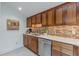 Kitchen area with stainless steel dishwasher and wood cabinetry at 1757 E Clifton Ne Rd, Atlanta, GA 30307
