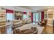 Cozy living room featuring a stone fireplace, built-in bookshelves, hardwood floors, and ample seating at 1757 E Clifton Ne Rd, Atlanta, GA 30307