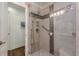 Modern shower with glass door, tile surround, and multiple shower heads at 1757 E Clifton Ne Rd, Atlanta, GA 30307