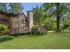 Picturesque backyard featuring a wooden deck, lush greenery, and natural landscaping at 267 Firecreek Rdg, Lawrenceville, GA 30046