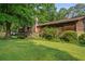 Serene backyard featuring a wooden deck, lush greenery, and natural landscaping at 267 Firecreek Rdg, Lawrenceville, GA 30046
