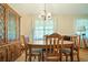 Dining room with wood table, china cabinet, chandelier, and windows at 267 Firecreek Rdg, Lawrenceville, GA 30046