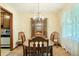 Dining room with wood table, china cabinet, chandelier, and bright natural light at 267 Firecreek Rdg, Lawrenceville, GA 30046