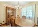 Dining room with wood table, china cabinet, chandelier, and window at 267 Firecreek Rdg, Lawrenceville, GA 30046