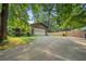 Spacious driveway leading to a detached garage on a property with mature trees at 267 Firecreek Rdg, Lawrenceville, GA 30046