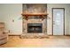 Close-up of the stone fireplace with a wooden mantel and decorative white entry door at 267 Firecreek Rdg, Lawrenceville, GA 30046
