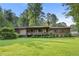 Charming single-story home featuring a large front yard and cozy porch with inviting decor at 267 Firecreek Rdg, Lawrenceville, GA 30046