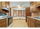 Well-lit kitchen with tile floors, cabinets, breakfast nook, and appliances at 267 Firecreek Rdg, Lawrenceville, GA 30046