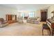 Bright living room with a classic piano, carpet flooring, and a cozy seating arrangement at 267 Firecreek Rdg, Lawrenceville, GA 30046