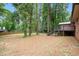 Spacious backyard view with privacy fence, mature trees, and deck with stairs attached to home at 2695 Peeler Rd, Dunwoody, GA 30360