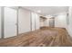 Finished basement with wood-look tile flooring, neutral paint, and access to unfinished storage at 2695 Peeler Rd, Dunwoody, GA 30360