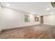 Finished basement with wood-look tile flooring, recessed lights, and bright neutral paint at 2695 Peeler Rd, Dunwoody, GA 30360