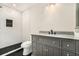 Bathroom with tiled shower, black floor tile, and a vanity with a granite countertop at 2695 Peeler Rd, Dunwoody, GA 30360