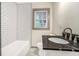 Bathroom featuring a tub and shower combination with white subway tile and a new sink and vanity at 2695 Peeler Rd, Dunwoody, GA 30360