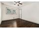Empty bedroom with hardwood floors and white walls features new windows at 2695 Peeler Rd, Dunwoody, GA 30360