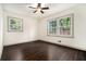 Empty bedroom with hardwood floors and two large windows showing a view at 2695 Peeler Rd, Dunwoody, GA 30360