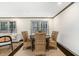 Elegant dining area featuring a wood table, neutral decor, and large windows at 2695 Peeler Rd, Dunwoody, GA 30360