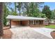 Charming single-story brick home with a convenient carport and freshly updated driveway at 2695 Peeler Rd, Dunwoody, GA 30360