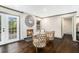 Cozy living room featuring a brick fireplace, white accents, and hardwood floors at 2695 Peeler Rd, Dunwoody, GA 30360