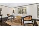 Stylish living area with hardwood floors, neutral decor, and ample natural light at 2695 Peeler Rd, Dunwoody, GA 30360