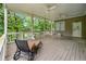 Covered back porch with multiple fans provides the perfect place to relax and enjoy the view at 5065 Nesbit Ferry Ln, Atlanta, GA 30350