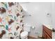 Bathroom featuring a novelty shower curtain, white toilet and sink at 5065 Nesbit Ferry Ln, Atlanta, GA 30350