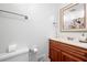 Small bathroom featuring white toilet, vanity and novelty shower curtain at 5065 Nesbit Ferry Ln, Atlanta, GA 30350
