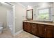 Bright bathroom featuring a double vanity, granite countertops, and shower at 5065 Nesbit Ferry Ln, Atlanta, GA 30350