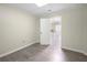 Bedroom features gray wood floors with an open doorway to the kitchen beyond at 5065 Nesbit Ferry Ln, Atlanta, GA 30350